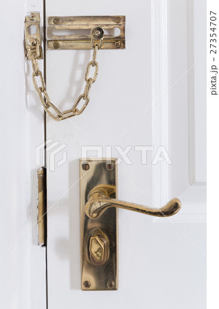 handle and chain on the white front door 27354707