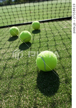 tennis balls on tennis grass court tennis balls on tennis grass court 27358619