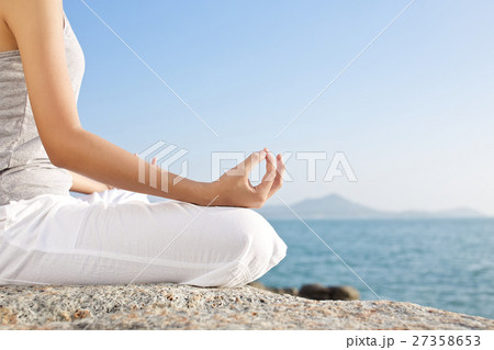 young woman meditation in a yoga pose on the tropi young woman meditation in a yoga pose on the tropi 27358653