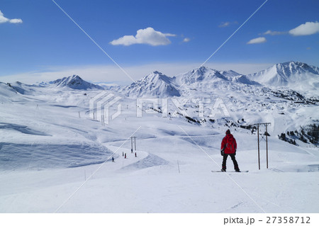 Snowboarding, skiing on fresh snow mountain slopes Snowboarding, skiing on fresh snow mountain slopes 27358712