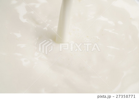 pouring milk into bowl from above pouring milk into bowl from above 27358771