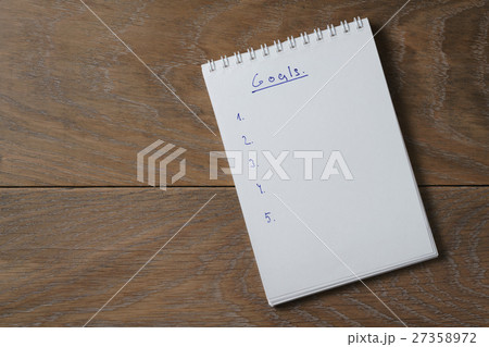 blank notepad on wooden table with word goals blank notepad on wooden table with word goals 27358972