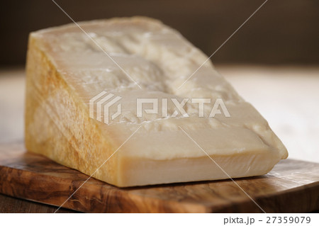 closeup of piece of italian parmesan cheese on closeup of piece of italian parmesan cheese on 27359079