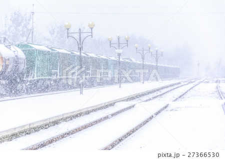 Blizzard on railway, freight train in snow Blizzard on railway, freight train in snow 27366530