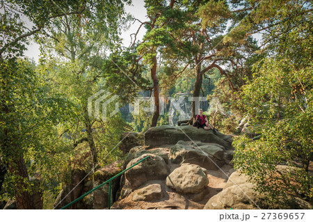 Young woman and her dog enjoy mountain hikes 27369657