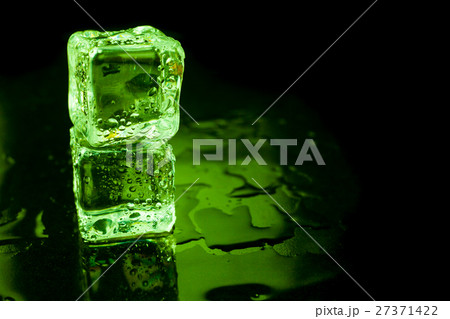 Wet ice cubes on black background with green light 27371422