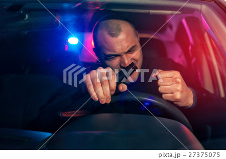 Angry drunk man sitting in car with beer bottle 27375075