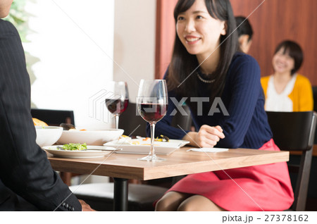 レストランで赤ワインを飲みながら食事するカップル レストランで赤ワインを飲みながら食事するカップル 27378162