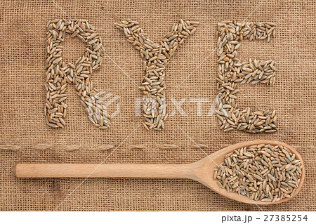 Inscription rye with a wooden spoon on burlap 27385254