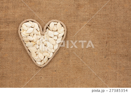 Heart made from rope with pumpkin seeds lying Heart made from rope with pumpkin seeds lying 27385354