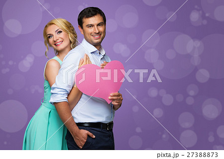 Beautiful couple holding pink heart 27388873
