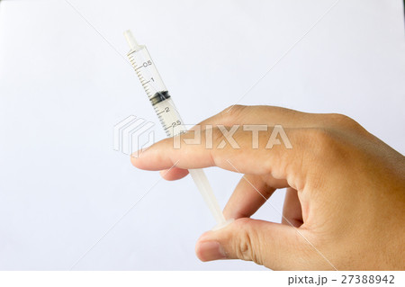 Man hold the plastic syringe on white background Man hold the plastic syringe on white background 27388942