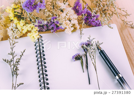Flower blossom put on blank notebook Flower blossom put on blank notebook 27391380