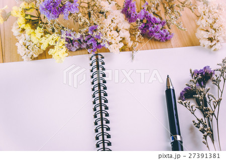 Flower blossom put on blank notebook Flower blossom put on blank notebook 27391381