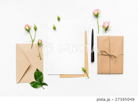 Letter envelope and gift with pink roses. Flat lay Letter envelope and gift with pink roses. Flat lay 27395049
