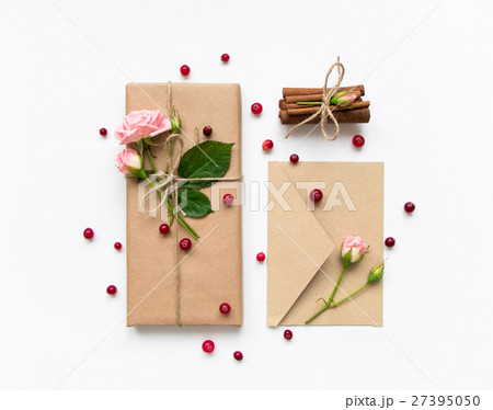 Gift and envelope with roses and berries. Flat lay Gift and envelope with roses and berries. Flat lay 27395050
