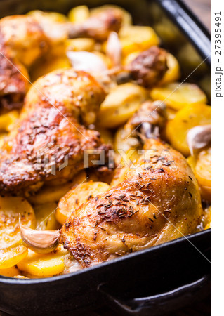 Roasted chicken leg with potatoes with caraway. Roasted chicken leg with potatoes with caraway. 27395491
