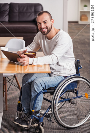 Enthusiastic disabled man having a great morning Enthusiastic disabled man having a great morning 27396104