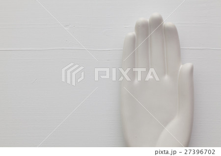 Detail of artifical hand on the wooden table Detail of artifical hand on the wooden table 27396702