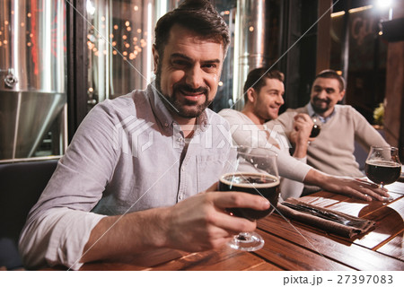 Handsome pleasant man enjoying his drink 27397083