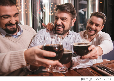 Joyful delighted men drinking alcohol 27397085