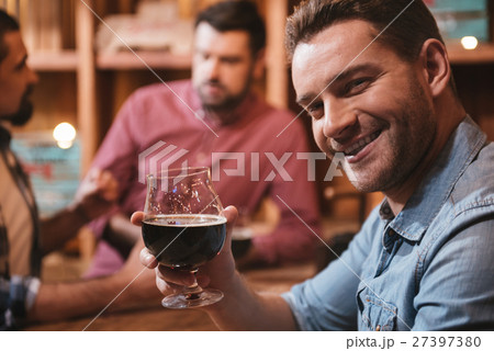 Handsome happy man drinking for you Handsome happy man drinking for you 27397380