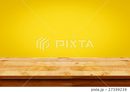 Empty of wooden table on yellow wall background. 27399239
