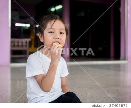 little asian  child girl eating a cookie 27405673