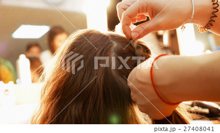 Female model getting her hair dressed 27408041