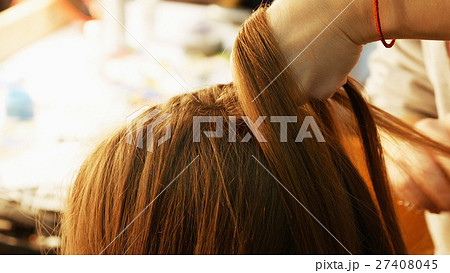 Female model getting her hair dressed 27408045