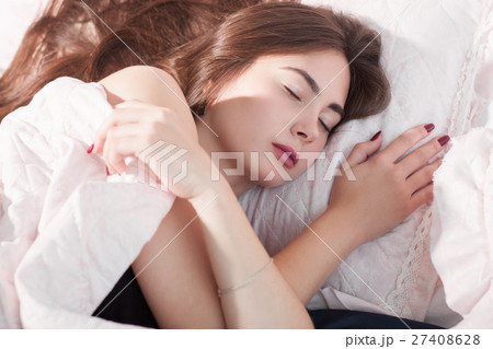 Frozen girl covering herself while sleeping in bed Frozen girl covering herself while sleeping in bed 27408628