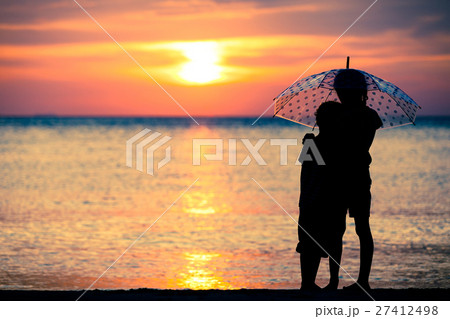 sad sisters and brother standing on the beach 27412498