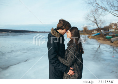 young beautiful couple on the ice of a frozen lake 27413381