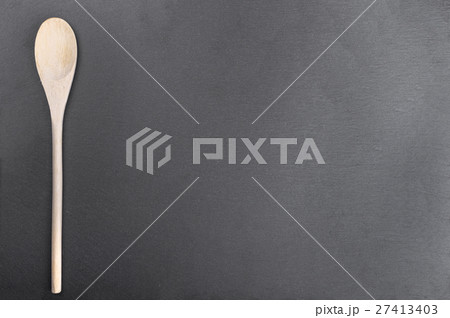 wooden spoon on slate blackboard 27413403