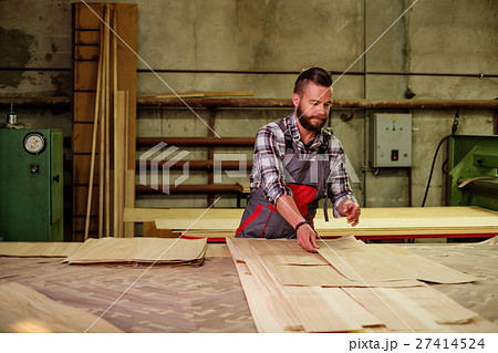 Carpenter doing his job in carpentry workshop Carpenter doing his job in carpentry workshop 27414524