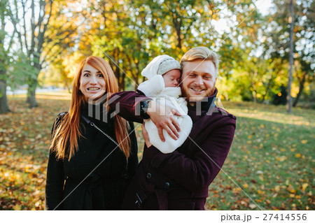 young family and newborn son in autumn park 27414556