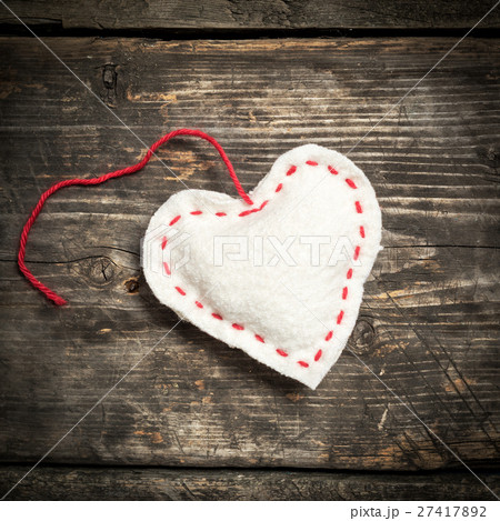 Colorful knitted hearts on the dark old boards 27417892