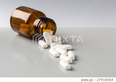 Glass bottle of white pills Glass bottle of white pills 27418564