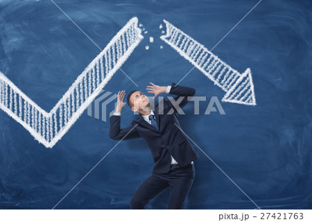 Businessman cowering on blue blackboard background 27421763