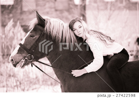 Girl laying on horse neck. Friendship background Girl laying on horse neck. Friendship background 27422598
