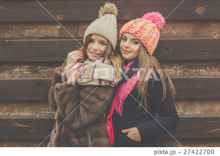 Two pretty girl are wearing warm winter clothes 27422700
