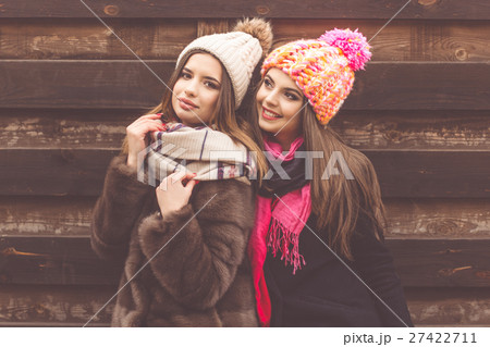 Two pretty girl are wearing warm winter clothes Two pretty girl are wearing warm winter clothes 27422711
