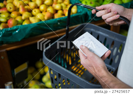 Man holding shopping basket and checklist 27425657