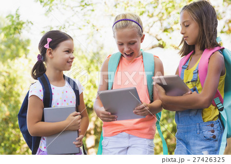 Happy school kids using digital tablet 27426325