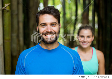 Couple standing in forest 27426984