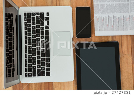 Laptop, digital tablet, mobile phone, and newspaper 27427851