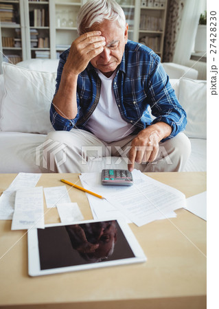 Tensed senior man checking the bills 27428230