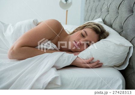 Young woman sleeping on her bed Young woman sleeping on her bed 27428313