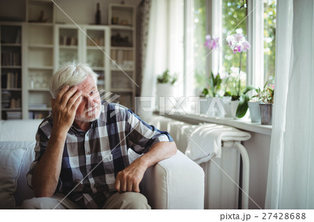 Tensed senior man sitting on sofa 27428688
