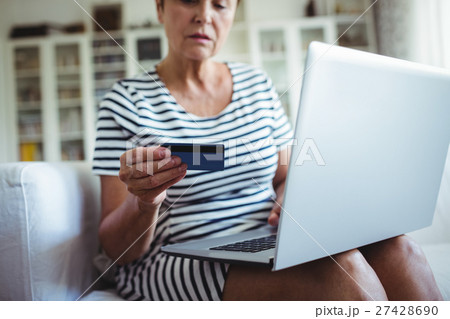 Senior woman doing online shopping on laptop Senior woman doing online shopping on laptop 27428690